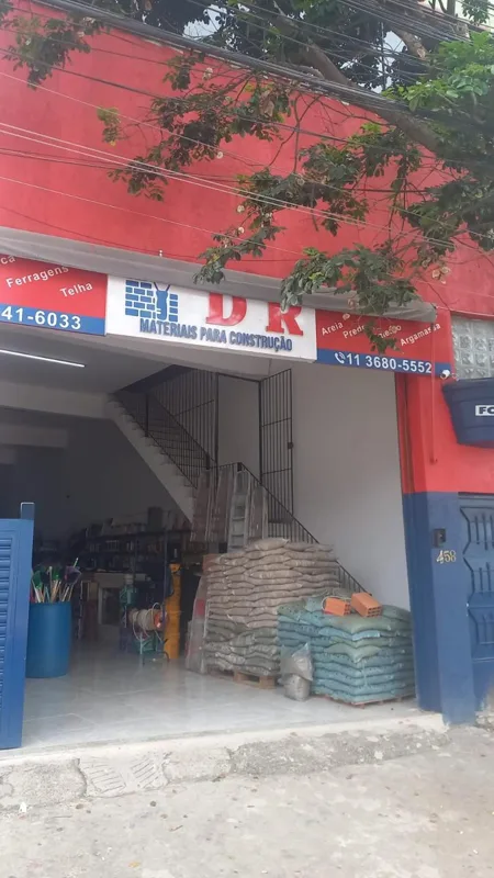Fachada de espaço comercial com acesso e materiais no térreo.